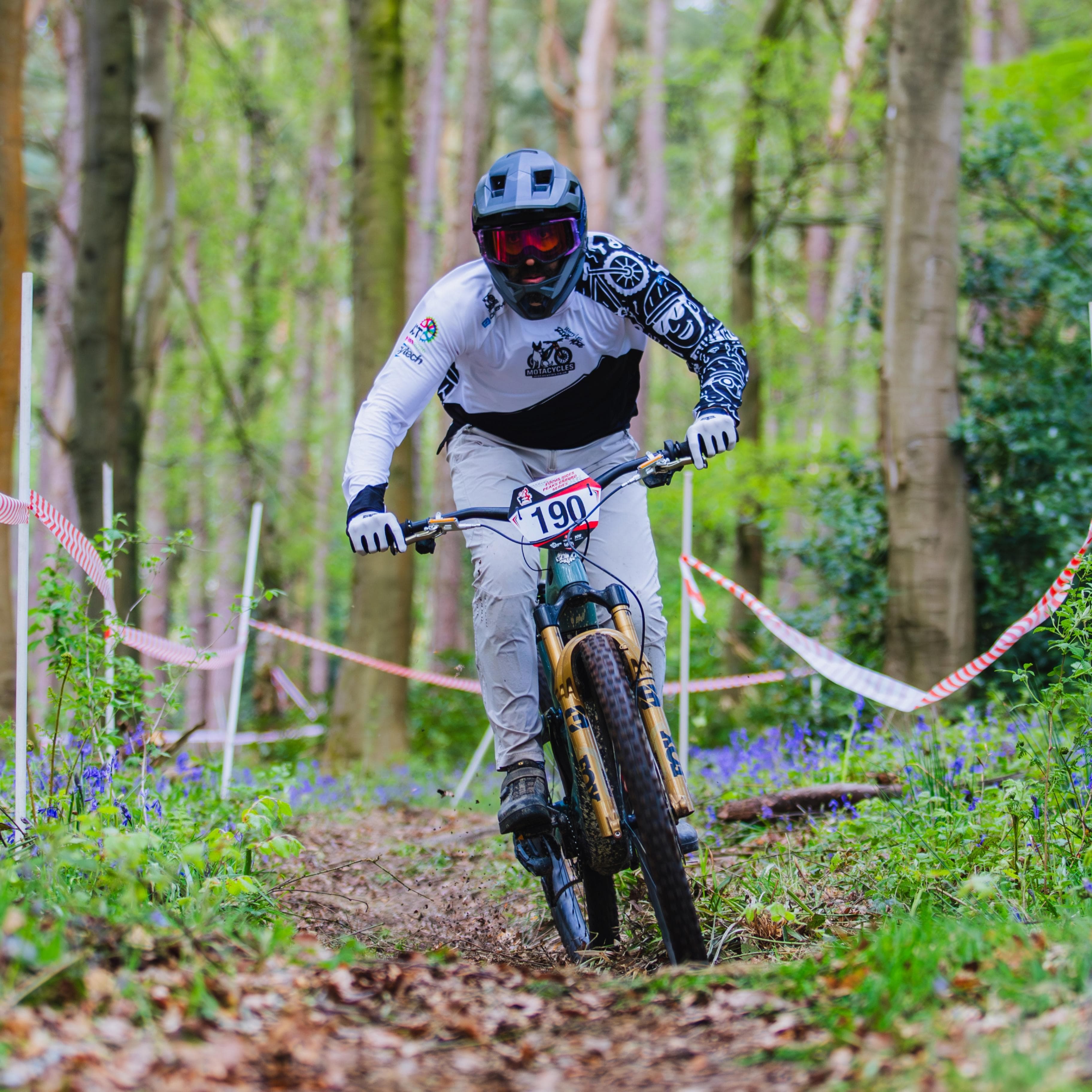 MotaCycles race team rider on track between the tapes